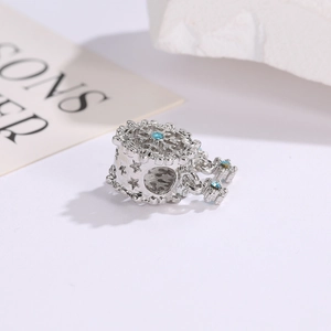 Macro shot of silver snowflake charm with light blue zircon for DIY beaded bracelets