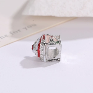 Detailed view of silver Christmas house charm with festive enamel colors and side hole