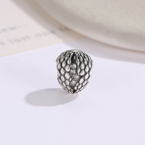 Retro silver dragon egg charm with scale texture and clear cubic zirconia stones