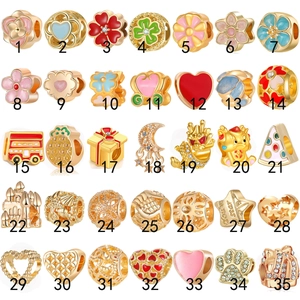 Golden alloy charm set with 35 unique floral and heart designs in a grid display