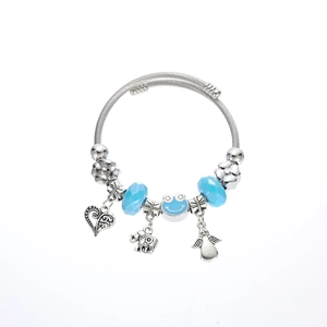 Close-up of beaded charm bracelet with silver elephant, heart, and blue glass beads