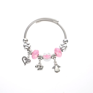 Close-up of pink frog pendant and silver beaded bracelet with heart and elephant charms