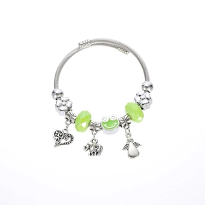 Detail of silver wire bracelet with green beads, frog charm and elephant pendants