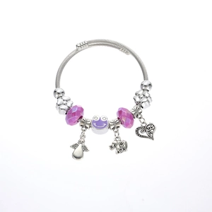 Detailed view of silver beaded bracelet featuring purple frog and elephant charms
