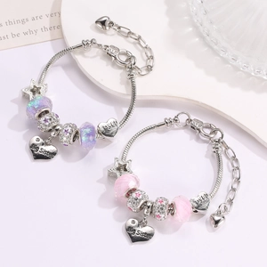 Detail of pink and purple beaded sister bracelets with 'Big Sister' heart charms