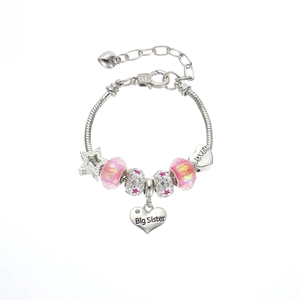 Detail of beaded charm bracelet with pink glass beads and Big Sister engraved heart pendant