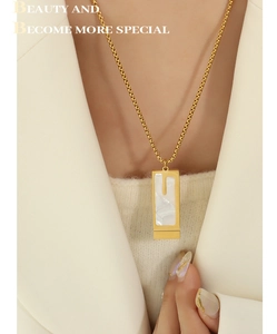 Detail shot of a minimalist double-layer bar pendant necklace on a female model