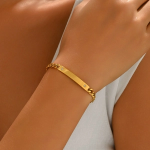 Gold-plated Cuban chain bracelet with a polished ID plate and sparkling zircon accents