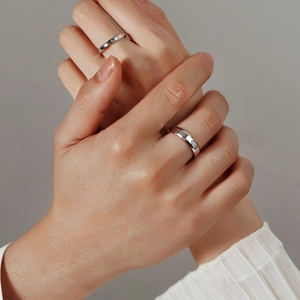 Minimalist titanium steel couple rings with Roman numeral engravings and small diamond inlay