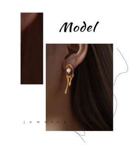 Detailed view of gold lava drop earrings featuring chain links and high-gloss shell pearls