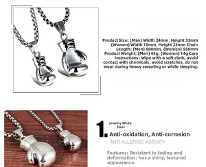Detailed close-up of polished stainless steel boxing glove pendants with size specifications