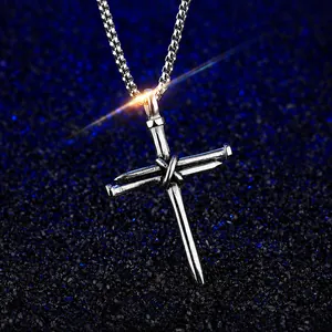 Macro detail of gothic cross pendant with nail design and vintage steel texture