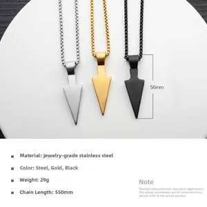Detailed view of spearhead pendants in silver, gold, and black finishes on a white tray