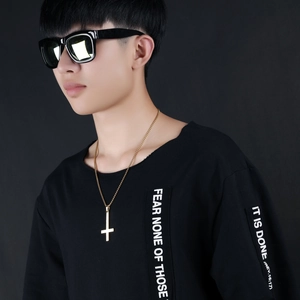 Classic gold inverted cross pendant necklace in stainless steel worn by a male model