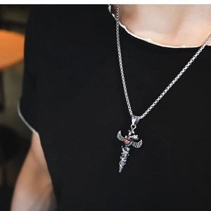 Gothic dagger pendant necklace with wings, serpent wrap, and a red heart gemstone detail