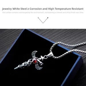Macro shot of gothic sword pendant with red heart gemstone and wings on box chain