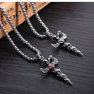 Detail of gothic sword pendants with red and black heart gems on a round link chain