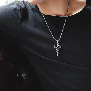 Men's gothic cross sword pendant necklace in silver finish worn on black t-shirt