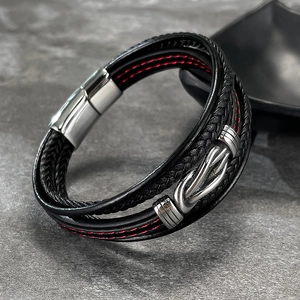 Close-up of multi-layer woven leather men's bracelet with red stitching and steel clasp