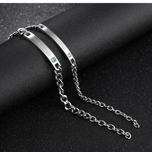 Close-up of His Queen and Her King engraved stainless steel couple bracelets with crown
