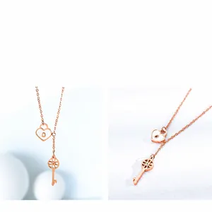 Close-up of rose gold titanium necklace with heart lock and hollow pattern key charms