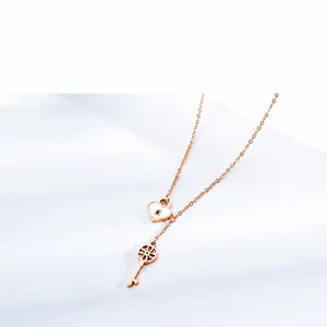 Detailed close-up of rose gold Y-shaped necklace with heart lock and hollow key pendants