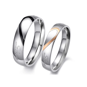 Matching heart couple rings in stainless steel with engraved Love lettering