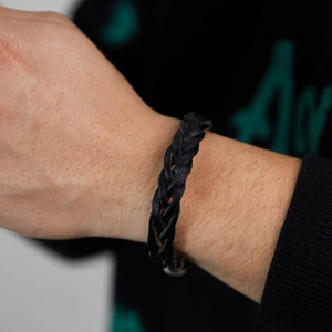 Handmade black woven leather bracelet with multiple strands for a minimalist street style