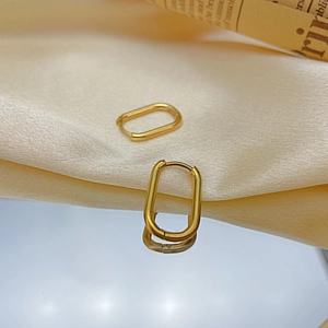 Minimalist golden geometric U-shaped titanium steel hoop earrings on satin