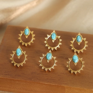 Three pairs of vintage sunburst design gold-plated titanium earrings with turquoise stones