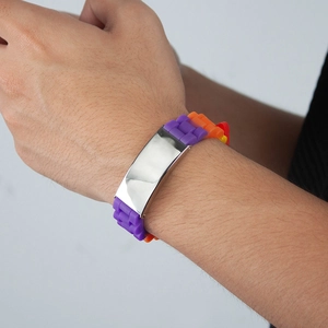 Macro view of a colorful rainbow silicone wristband with polished stainless steel plate