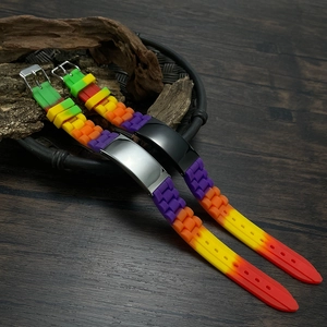 Close-up of rainbow gradient silicone wristbands with silver and black metal buckles
