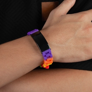 Rainbow silicone link bracelet with black metal plate worn on a wrist, hip hop jewelry