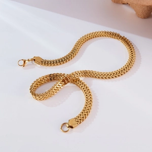 Close-up of golden titanium steel Cuban necklace showing V-shaped weaving detail