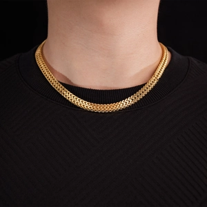 Classic gold Cuban link titanium steel necklace for men on a black sweater background