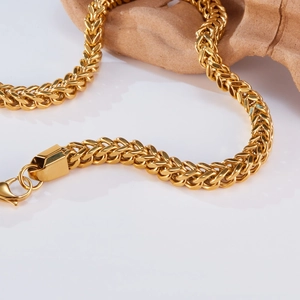 Close-up of golden stainless steel Cuban link chain with a sturdy lobster clasp closure