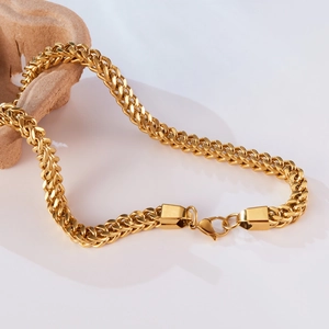 Detailed close-up of golden stainless steel Franco chain with a secure lobster clasp