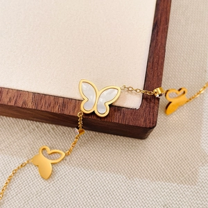 Elegante bracciale in acciaio dorato con farfalle in madreperla bianca e zirconi lucidi