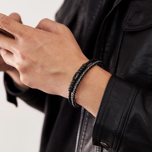 Detail of double-layer black braided leather bracelet with stainless steel magnetic clasp