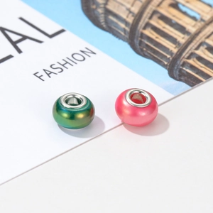 Detail of colorful resin DIY beads with silver metal cores on a fashion background