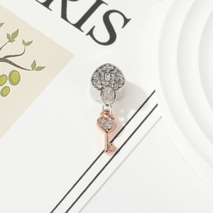 Sparkling heart lock and key charm with pave cubic zirconia in two-tone silver and rose gold