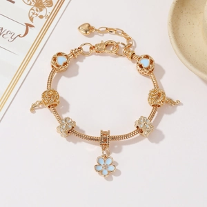 Gold beaded cherry blossom charm bracelet with blue enamel hearts for women
