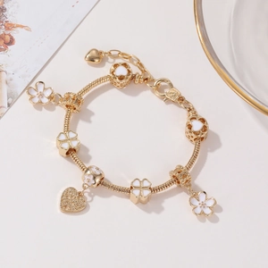 Golden cherry blossom beaded charm bracelet with heart pendant and flower charms