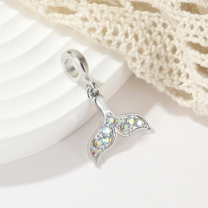 Sparkling mermaid tail pendant with colorful crystals on a white geometric display