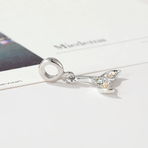 Macro shot of silver fishtail pendant with colorful zircon stones for DIY jewelry making