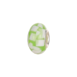 Macro detail of a green and white mosaic glass charm bead with a metal core for DIY bracelets
