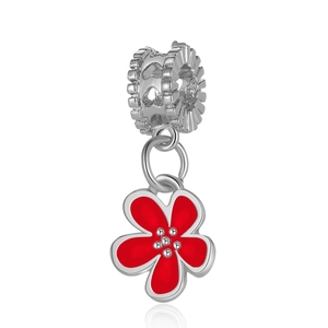 Macro view of silver gear-shaped charm with red enamel flower and sparkling rhinestone