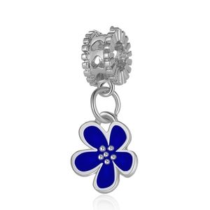 Detailed macro view of silver flower pendant with blue enamel and hollow heart charm