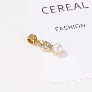 Golden bunny pendant with white pearl and sparkling crystals on minimalist fashion background