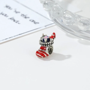 Detailed macro view of a red and white striped Christmas stocking charm with candy cane